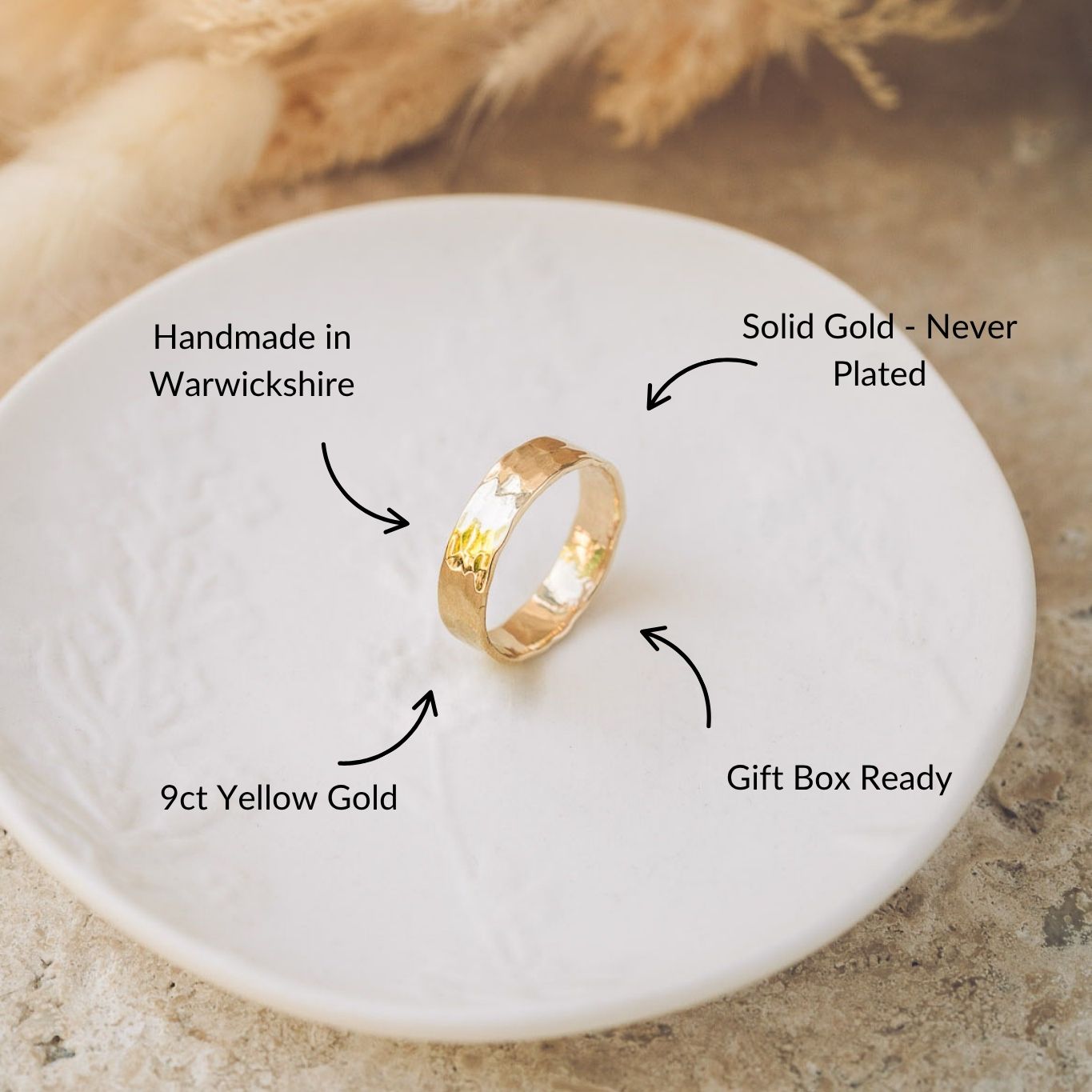 Gold ring on a white dish with text highlighting that it's handmade in warwickshire, and made from solid gold