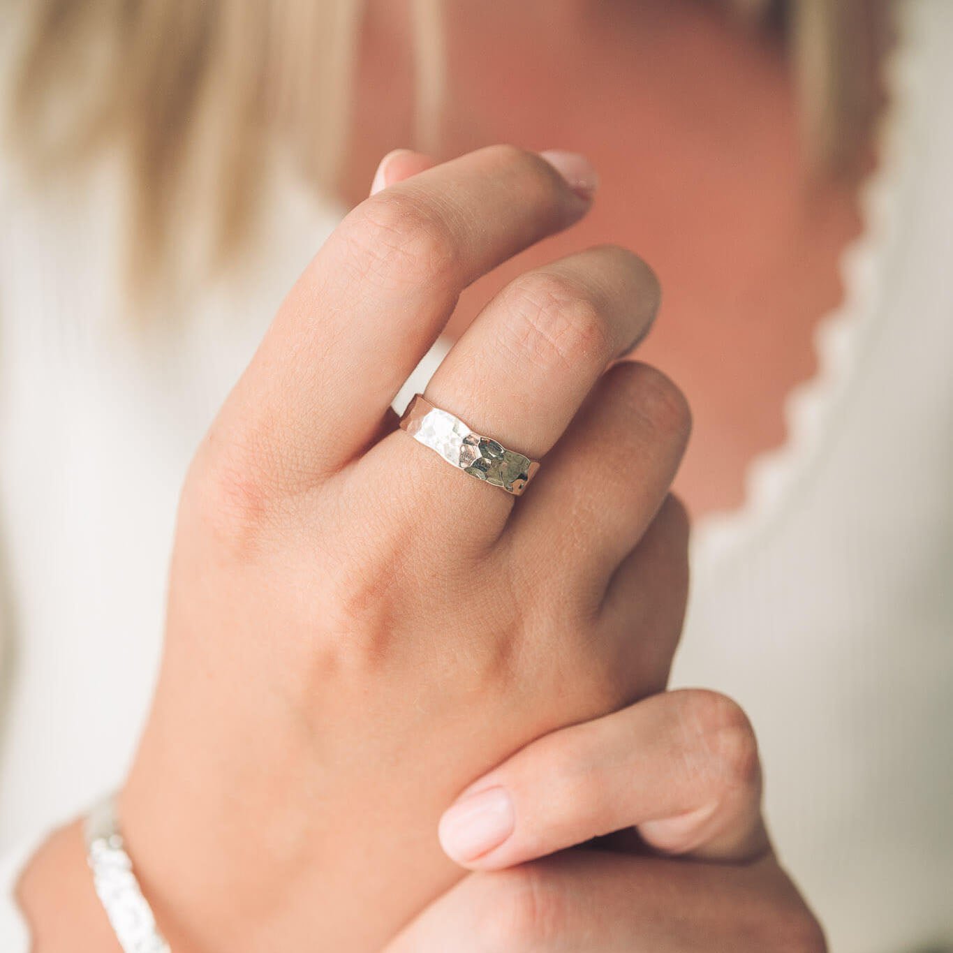 Hammered silver ring on hand