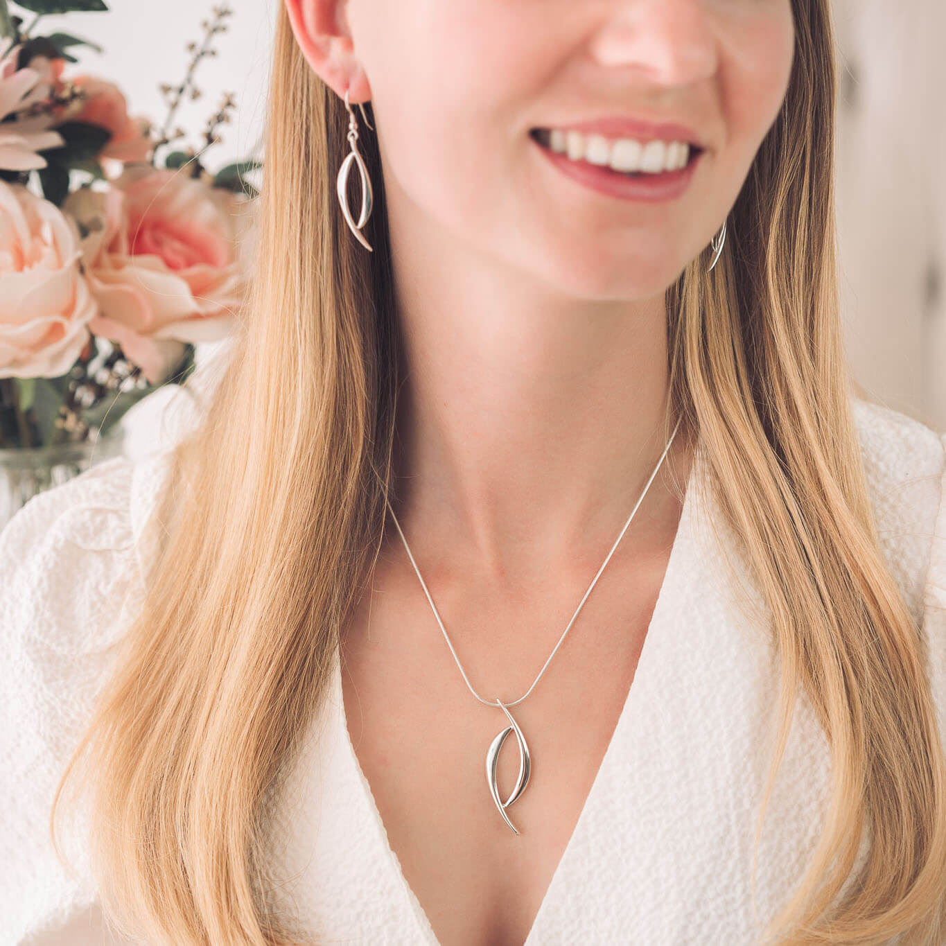 sterling silver pendant and earrings on woman