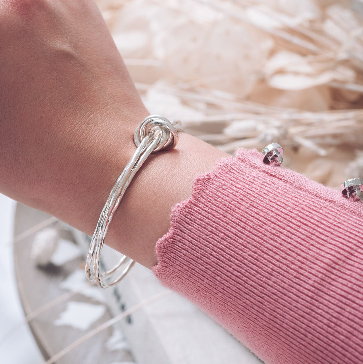 Three Intertwined Hammered Bangles with Silver Knot