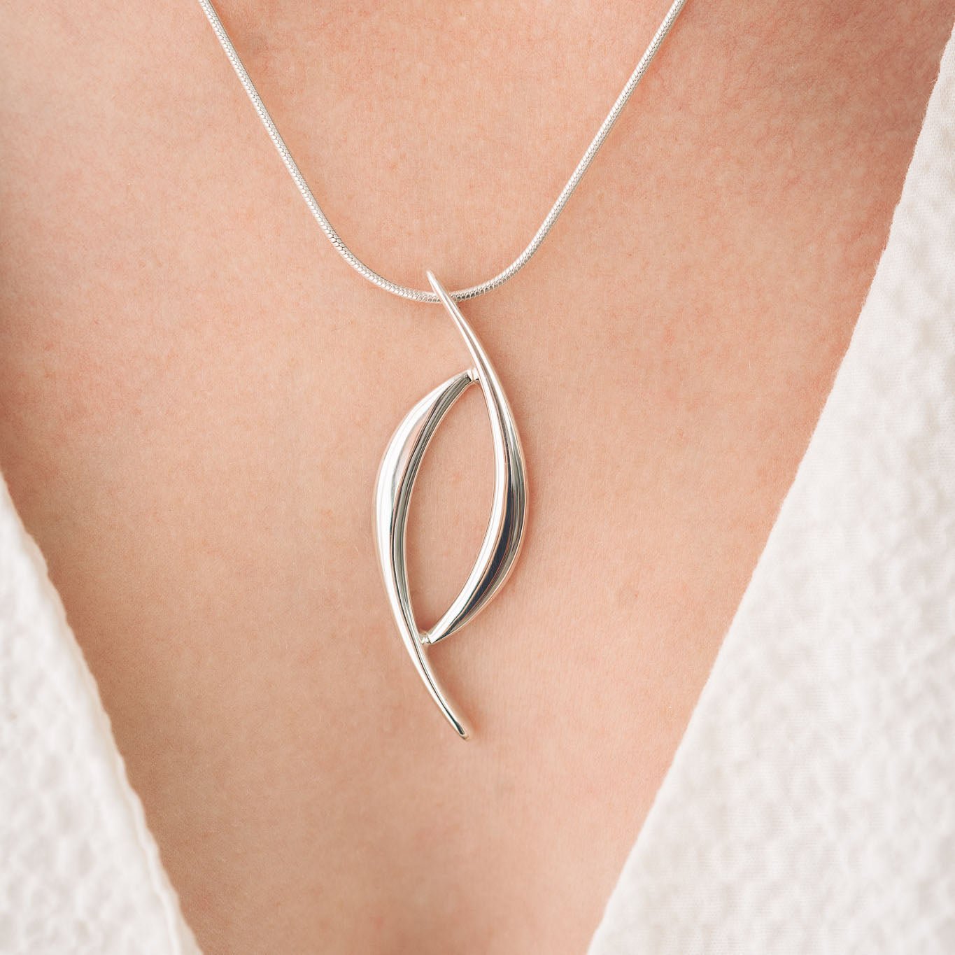 Silver pendant on neck