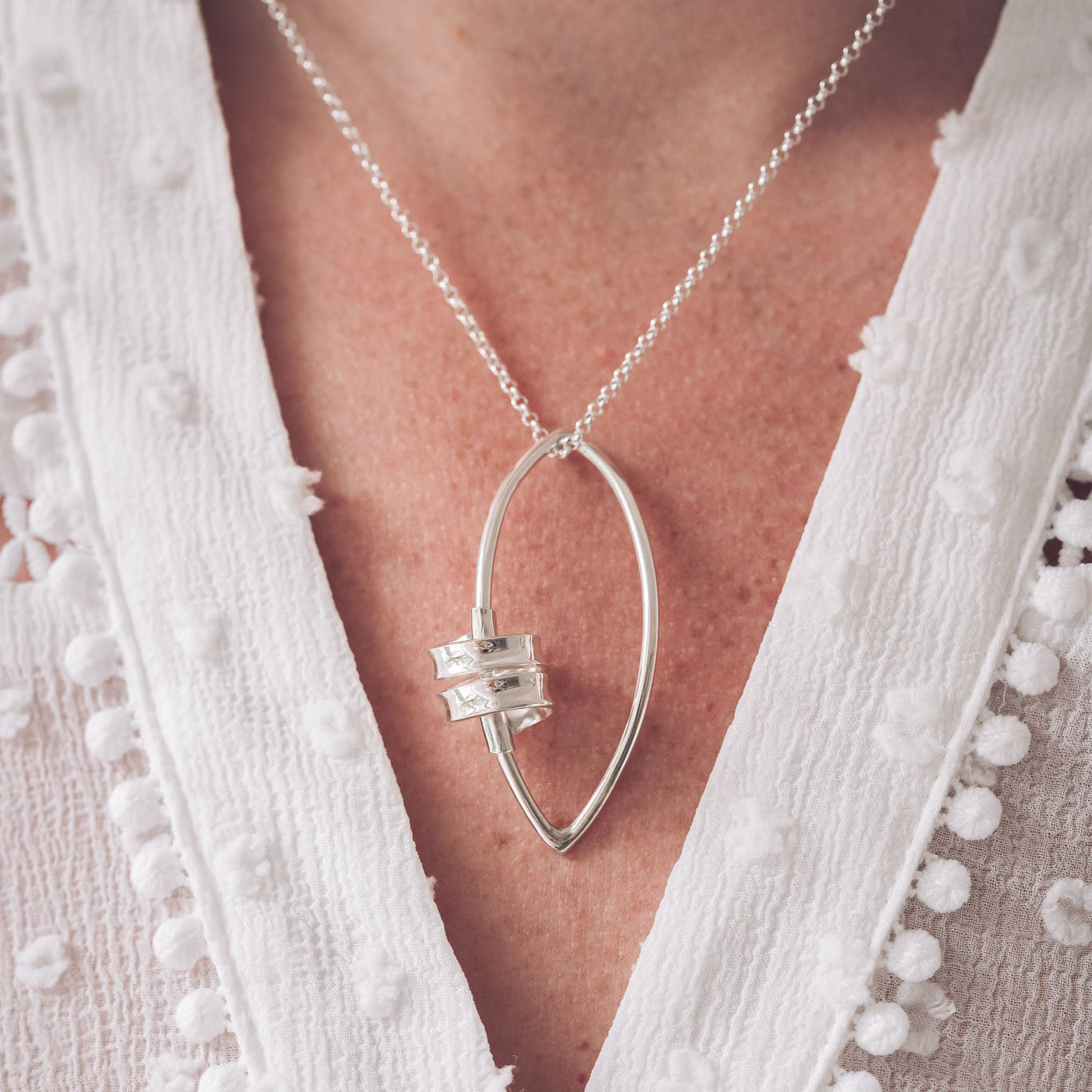 Handmade Sterling Silver Ribbon Pendant on our Marquise Frame